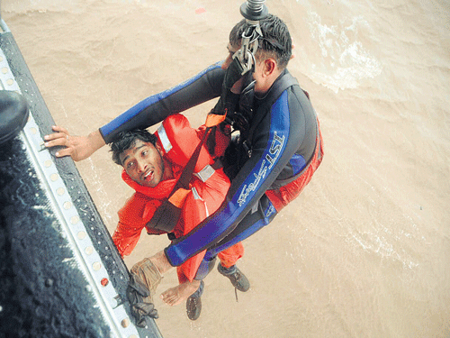 Indian Navy and Coast Guard personnel rescue seamen from MV Coastal Pride that sunk off Daman on Wednesday. DH photo