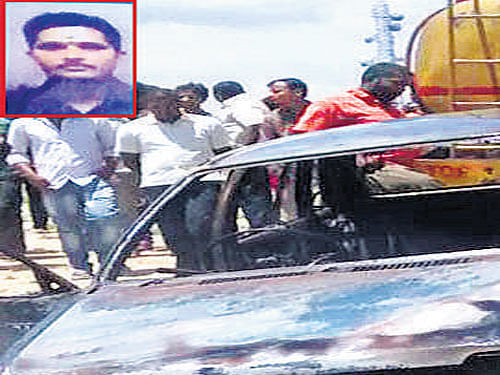 The car in which Shivashankar Hebbar (inset) set himself ablaze in Vishweshwaraiah Layout in Kumbalgodu on Thursday. DH PHOTO