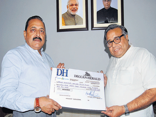Deccan Herald's Political Editor Shekhar Iyer (right) hands over a cheque for Rs 2,00,33,910, raised through the Deccan Herald-Prajavani Relief Fund for Nepal reconstruction to Minister of State in PMO Dr Jitendra Singh. DH photo
