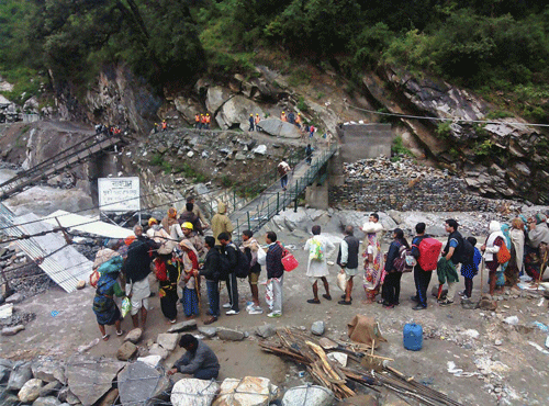 Pilgrims remain stranded after roads and bridges collapsed due to heavy rainfall near Sonprayag, in Kedarnath on Friday. PTI Photo