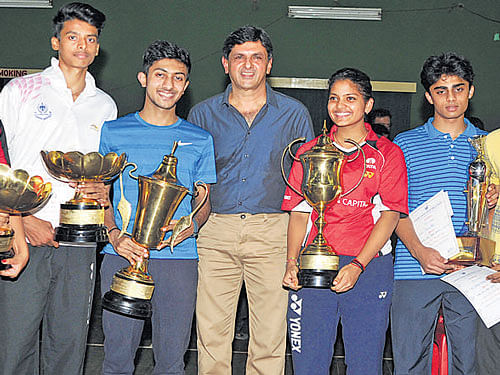CHAMPS | Winners of the State-ranking badminton tournament pose with legend Prakash Padukone in Bengaluru on Friday. From left: Mithula UK (girls' U-17 singles), Ashwini Bhat (girls' U-17 singles & doubles), B Kiran (boys' U-17 singles), Sahil Sipani Prakash (boys' U-19 singles), Mahima Agarwal (girls' U-19 singles), Kevin ML (U-17 boys' doubles), Nikhil Shyam Shiva (boys' U-17 doubles) and Sudeep Suresh (boys' U-19 doubles) and Siddarth (boys' U-19 doubles. ) DH PHOTO