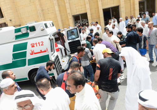 People help carry injured victims to ambulances outside Imam al-Sadeq Mosque, after a suicide bomb attack, in Kuwait city. Reuters photo
