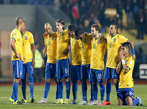 Brazil players watch during a penalty shooutout in which they were defeated by Paraguay in their Copa America 2015 quarter-finals soccer match at Estadio Municipal Alcaldesa Ester Roa Rebolledo in Concepcion. Reuters photo