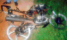 The mangled remains of the bike which caught fire after  colliding head-on with another bike on Magadi Road on Sunday night. DH photo