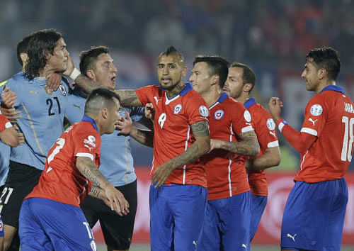 Edinson Cavani argues with Chile's Gonzalo Jara. AP Photo