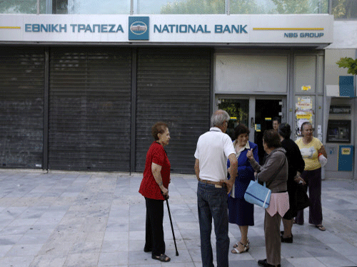 Elderly people, who usually get their pensions at the end of the month, wait outside a closed bank in Athens, ap photo