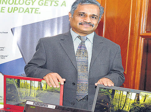 Acer India CMO S Rajendran poses with the company's new devices. DH PHOTO