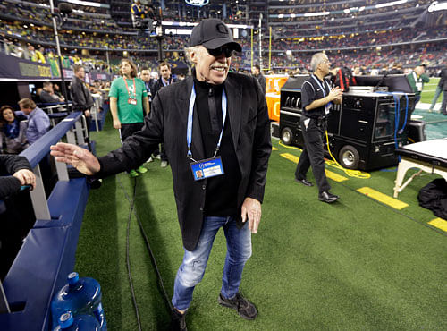 Nike Chairman Phil Knight walks near the field before the NCAA college football playoff championship game between Ohio State and Oregon in Arlington, Texas. AP file photo