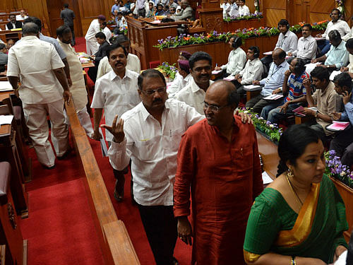 Opposition BJP members walking out demanding CBI inquiry in Lokayukta Corruption, at Legislative Council during the Monsoon Sessions at Suvarna Soudha in Belgavi on Thursday. DH photo