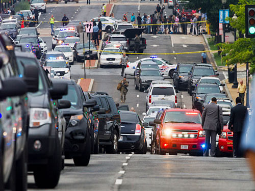 A police presence blocks M Street Southeast near the Navy Yard in Washington, Thursday, July 2, 2015. The Washington Navy Yard was on lockdown Thursday morning after reports of gunshots, but a senior federal law enforcement official says there has been no confirmed report of any shooting. AP Photo