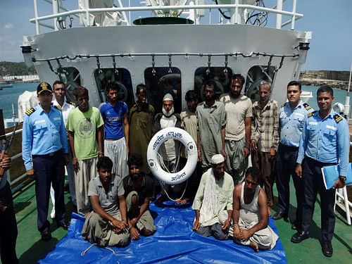 The occupants of the ship which the Coast Guard intercepted as a suspicious foreign fishing 'dhow', seen off the Alapuzha coast and brought to Vizhinam, on Sunday. PTI Photo