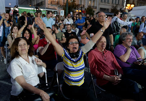 Supporters of the No vote react after the first results of the referendum at Klafthmonos square in Athens. AP Photo