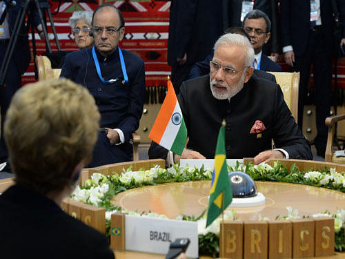 Brazil's President Dilma Rousseff , left, and Indian Prime Minister Narendra Modi, right, attend BRICS (Brazil, Russia, India, China, South Africa) summit in Ufa, Thursday, July 9, 2015. AP Photo.