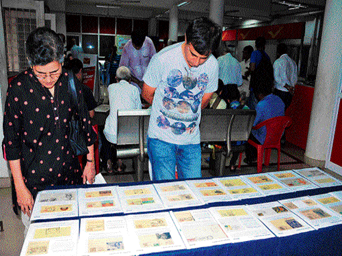 People watch the collection of permanent picture cancellations during an exhibition at Head Post Office in Mangaluru on Sunday. K Sridhar, the philatelist (Inset). DH photos