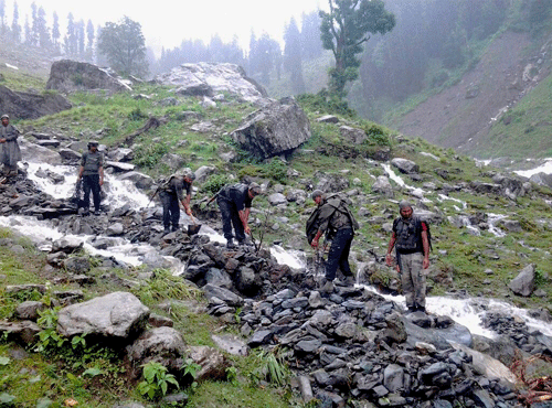 Rashtriya Rifles and State Disaster Response Fund (SDRF) team members searching for missing pilgrims after a cloudburst. PTI file photo