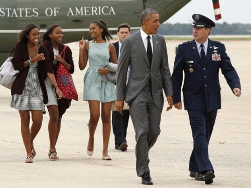 Obama and daughter Sasha (R), along with two of Sasha's friends, board Air Force One as they depart Joint Base Andrews in Washington. Reuters photo