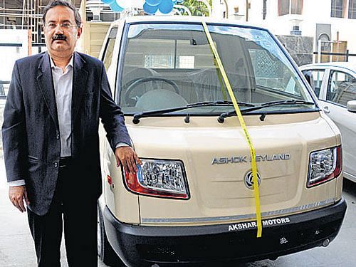 Nitin Seth poses with the Ashok Leyland Dost in Bengaluru on Monday. DH Photo by B H Shivakumar