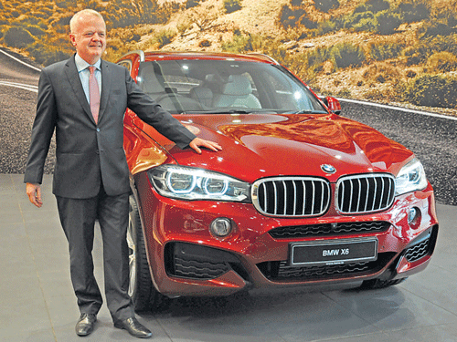 BMWGroup India President Philipp von Sahr poses with the newX6 SAC n Bengaluru on Thursday. DH PHOTO BY S K DINESH
