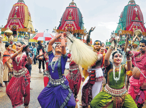 A group of dancers perform in front of three chariots in Puri on Sunday. DH PHOTO