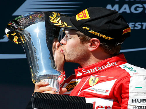 Winner Ferrari Formula One driver Sebastian Vettel of Germany kisses the trophy after the Hungarian F1 Grand Prix at the Hungaroring circuit, near Budapest, Hungary July 26, 2015. Reuters Photo.