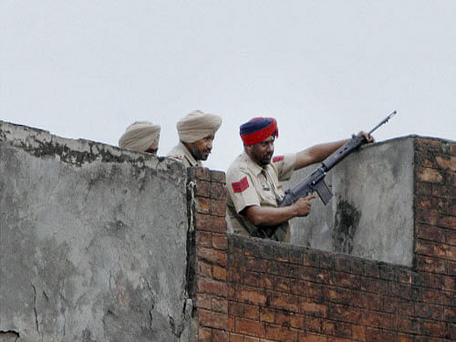 Police personnel during an encounter with militants who attacked a police station at Dinanagar in Gurdaspur district on Monday. PTI Photo
