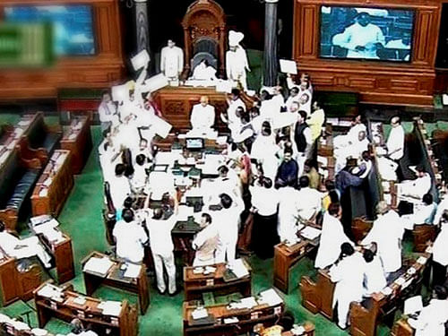 Opposition members protest in Lok Sabha in New Delhi on Monday. PTI Photo