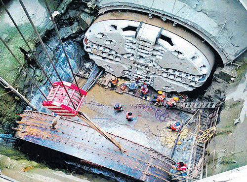 DRILLING AWAY: Namma Metro workers fit the new cutter head into the Tunnel Boring Machine, Godavari, near the Sampige station in Bengaluru on Monday. DH PHOTO