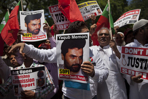 Social Democratic Party of India (SDPI) activists carry placards with photographs of 1993 Mumbai blasts convict Yakub Memon during a protest outside the Maharashtra House demanding abolition of death penalty in New Delh on Monday. AP