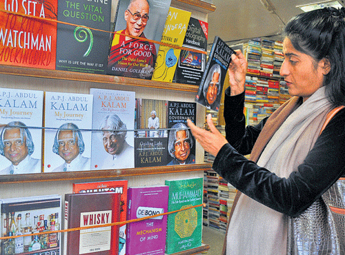 A woman looks at books authored by former president A P J Abdul Kalam at a book shop on Church Street on Tuesday.