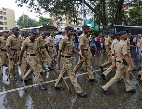 policemen patrol a road near to the residence of Memon in Mumbai. Reuters Photo