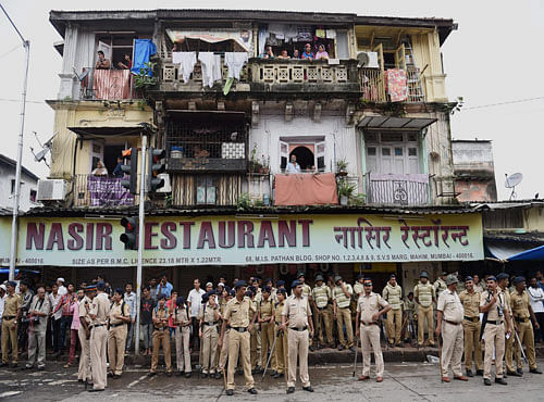 Police personnel stand guard outside Yakub Memon's house in Mumbai on Thursday. Memon, convicted for the 1993 blasts in Mumbai, was hanged a little before 7 am at Nagpur Central Prison on Thursday. PTI Photo