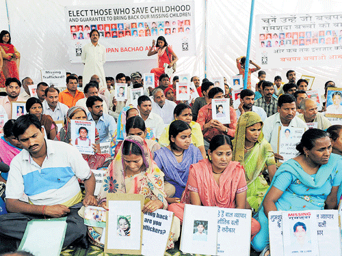 agonising wait: In this file photo, parents hold pictures of their missing children during a demonstration in New Delhi on April 24, 2009. Police say that kidnapped children are often forced into prostitution, begging and forced labour. Ransoms are rarely demanded. AFP