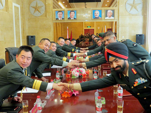 Personnel of Indian Army and People's Liberation Army (PLA) at the Ceremonial Border Personnel Meetings (BPMs) at Daulat Beg Oldie in Ladakh on Saturday. PTI Photo