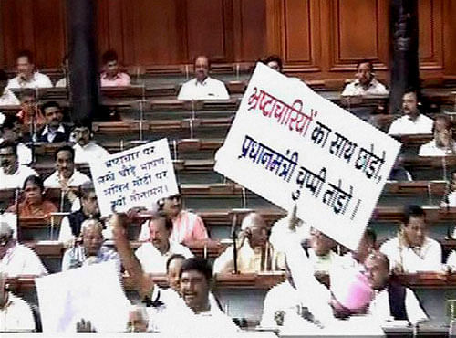 Opposition members protest in the Lok Sabha in New Delhi on Monday. PTI Photo
