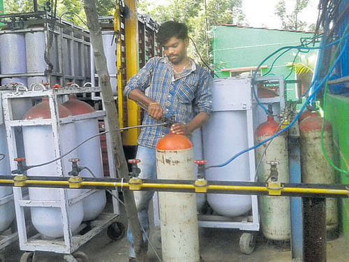Clean & Green An employee refills cylinders at the Maltose plant in Doddaballapura.  Photo by pramod S