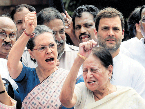 Determined lot: Congress President Sonia Gandhi shouts slogans with party vice-president Rahul Gandhi, senior leader Mohsina Kidwai and other leaders during a protest against suspension of 25 party members, at parliament on Tuesday.  PTI