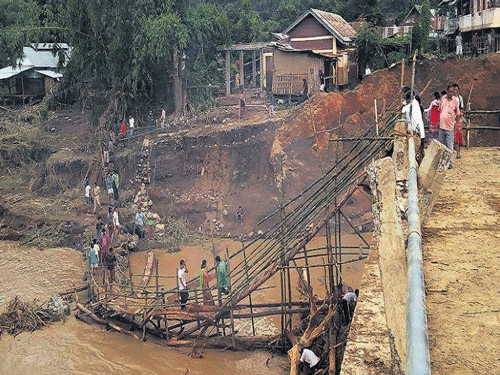 The temporary bridge built by villagers after Chakpikarong  bridge - that serves more than 40,000  people of both Thoubal and Chandel districts of Manipur- collapsed on July 31 due to flash floods. DEEPAK OINAM