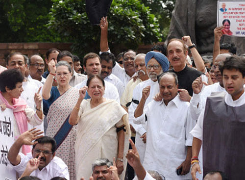 Congress President Sonia Gandhi shouting slogans with party leaders during a protest against suspension of 25 party members, at parliament in New Delhi on Tuesday. PTI Photo