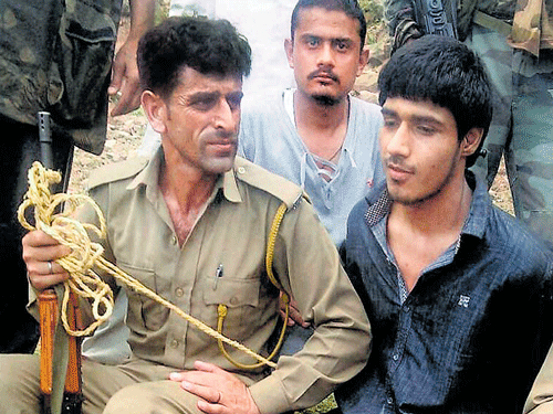 Police with the apprehended terrorist at Udhampur district of Jammu and Kashmir. PTI