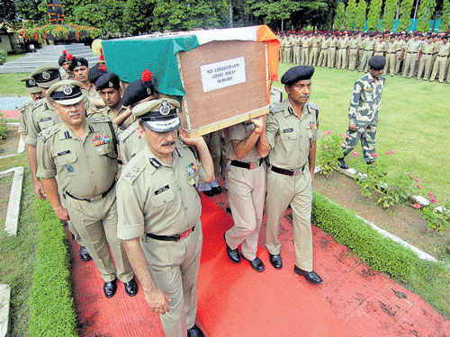 Paying Last Respects:  BSF officers carry the coffin of a soldier who was killed in militant attack at Jammu- Srinagar National Highway in Udhampur, during the wreath laying ceremony in Jammu on Thursday. PTI