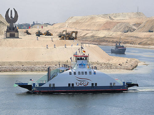 cruising forward: A ship named 'Long life Egypt' crosses the new Suez Canal after its opening ceremony in Ismailia, Egypt on Thursday. President Abdel Fattah el-Sisi hopes this extension will power an economic turnaround in the Arab world's most populous country.  REUTERS