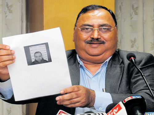 DG and IGP Om Prakash displays a photograph of Bannanje Raja at a press meet in Bengaluru on Friday. DH Photo
