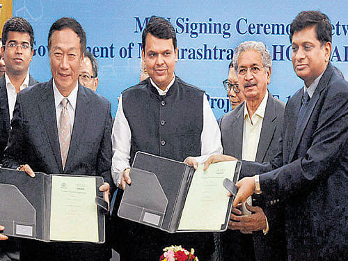 giant leap: Maharashtra Chief Minister Devendra Fadnavis and founder and chairman of Foxconn Technology Terry Gou display the MoU for an investment of $5 billion from the                  Taiwanese electronics major in Mumbai on Saturday. Pti