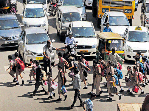 Students and parents are crossing the road in front of Sophia School