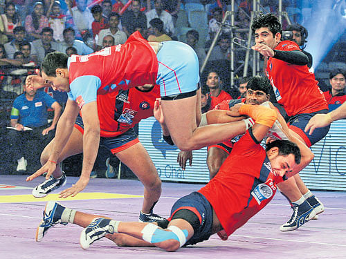 grab him!: Dabang Delhi players try to catch Jasvir Singh (top) of Jaipur in a Pro Kabaddi league match in New Delhi on Monday. Jaipur defeated Delhi 51-21.