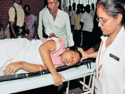 An injured devotee is brought to Rajendra Institute of  Medical Science in Ranchi on Monday. PTI