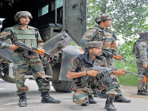 On guard: Army personnel during an encounter with militants at Ratnipora in Pulwama district of South Kashmir on Tuesday. PTI