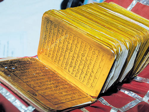 Busted: The 10-member gang of antique peddlers, which was arrested in Mysuru district for trying to sell a Qur'an of antique value. The copy of the Qur'an seized by the police.  dh photos