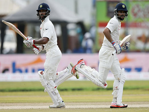 India's captain Kohli and his teammate Dhawan runs between wickets during the second day of their first test cricket match against Sri Lanka in Galle. Reuters