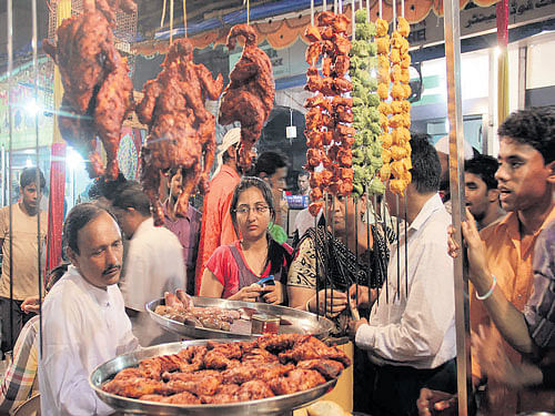 Customers wait before a shop in Mumbai. Mrityunjay Bose